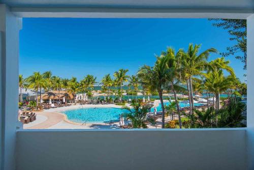 a view of a resort with a pool and palm trees at Hawks Cay Resort in Marathon