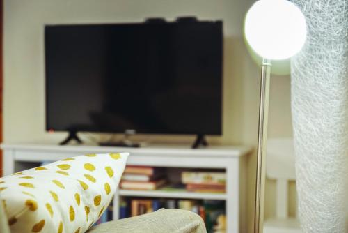 a living room with a tv and a pillow and a lamp at C'era una "volta"... un appartamento a Torino in Turin