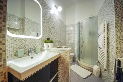 uma casa de banho com um lavatório, um chuveiro e um WC. em C'era una "volta"... un appartamento a Torino em Turim