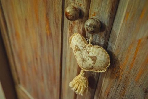a butterfly is hanging on a wooden wall at C'era una "volta"... un appartamento a Torino in Turin