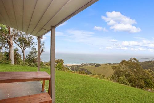a wooden porch with a view of the ocean at Beacon Point Ocean View Villas in Apollo Bay