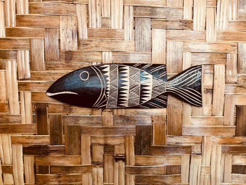 a painting of a fish on a wooden floor at Everyday Sunday Hotel & Cafe in Bantayan Island