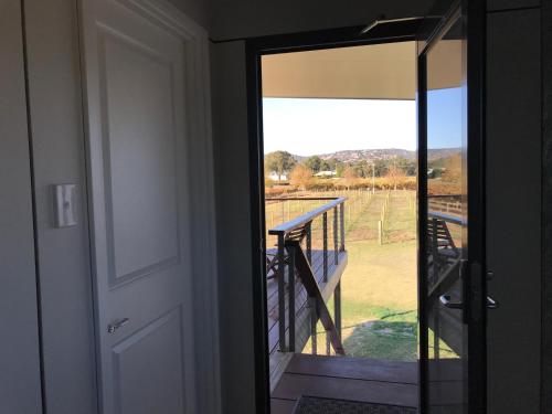 a door to a balcony with a view of a porch at Lot113 Vineyard Accommodation in Upper Swan