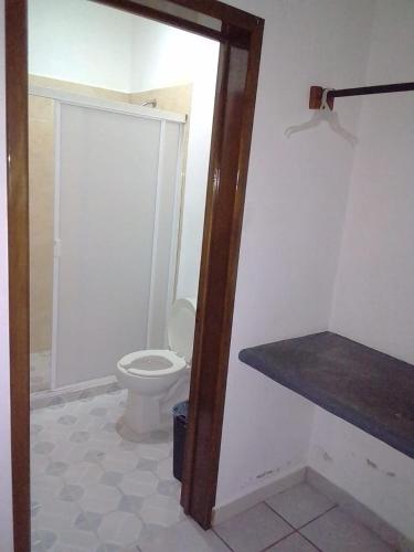 a bathroom with a white toilet in a room at Balcon Gueela in Santa Cruz Huatulco