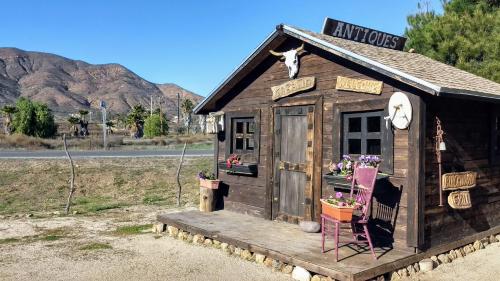 a small wooden building with a sign on it at Fernabella's Lodge in Valle de Guadalupe