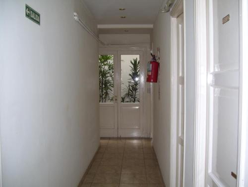a hallway with a door with plants in it at Apolo Atlantis in Mar del Plata