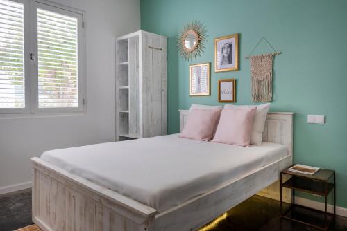 a bedroom with a large bed with pink pillows at BOHO Bohemian Boutique Hotel in Willemstad