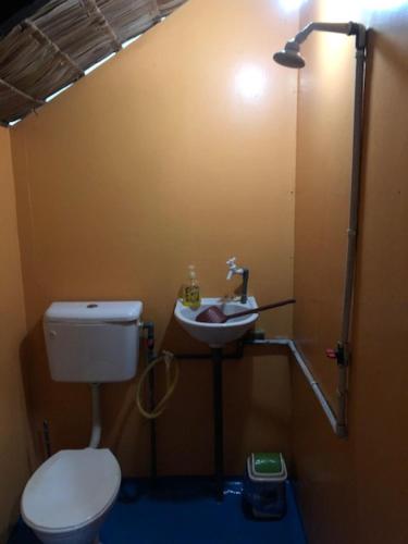 a bathroom with a toilet and a sink at Beach Shack Chalet - Garden View Aframe Big Unit in Tioman Island