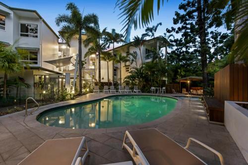 a swimming pool in front of a building at The Lookout Resort Noosa in Noosa Heads