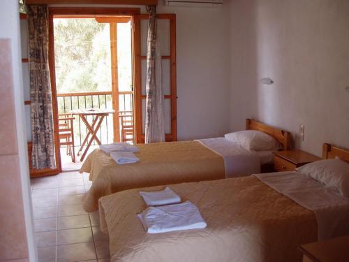 Ένα ή περισσότερα κρεβάτια σε δωμάτιο στο Βίλα Καβουράκια