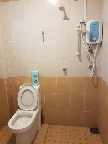 a bathroom with a toilet and a shower at White House Homestay in Ipoh