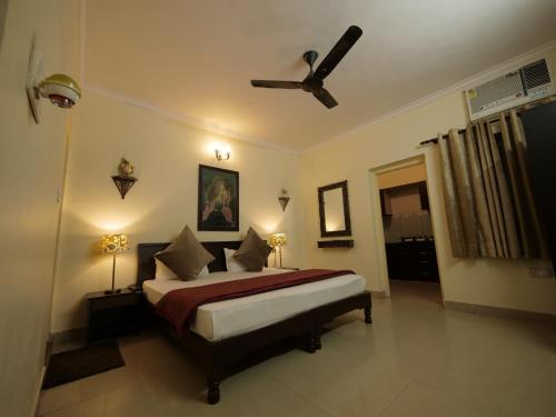 a bedroom with a bed and a ceiling fan at The Buddhayan Villa in Jaipur