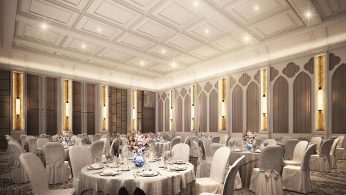 a banquet hall with white tables and chairs at Mövenpick Myth Hotel Patong Phuket in Patong Beach
