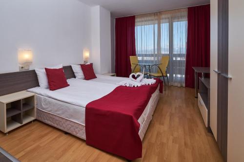 a bedroom with a large bed with a red blanket on it at Mountain Paradise by the Walnut Trees - Free wellness in Bansko