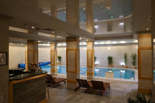 a hotel lobby with a pool in the background at 7 Pools SPA Boutique Hotel in Bansko