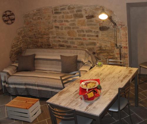 a room with a table and a bed and a table and chairs at Langa 4 Love in Novello