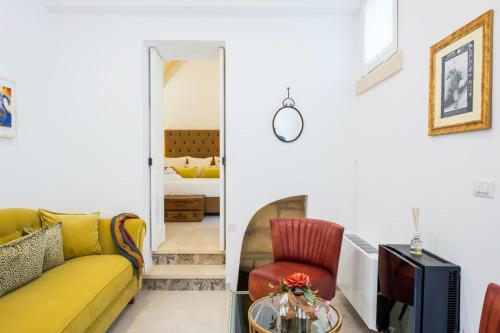 a living room with a couch and a tv at Amatè Suite in Lecce