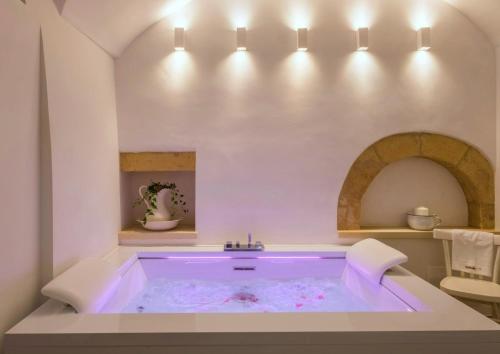 a large bath tub in a white bathroom at Amatè Suite in Lecce