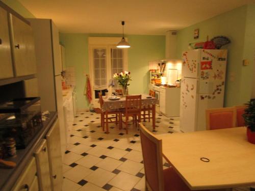 a kitchen with a table and a dining room at La maison de Mathilde in Saint-Jean-de-la-Motte