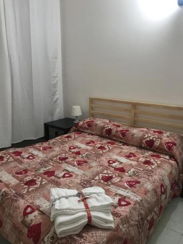 a bedroom with a bed with towels on it at Villa belvedere in Pontecagnano