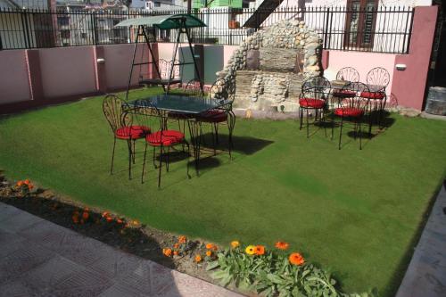 a group of chairs and a table on a lawn at Sitapaila Home Stay and Apartment in Kathmandu