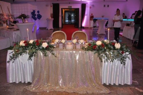 a table with a bunch of flowers on it at Hotel Zamek Pułtusk Dom Polonii in Pultusk