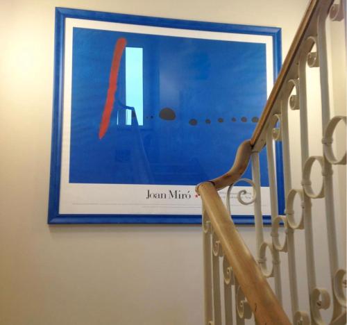 a picture hanging on a wall next to a staircase at Blu Hotel in Lavagna