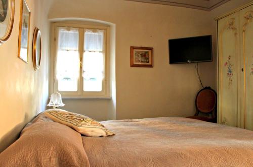 a bedroom with a bed with a pillow and a window at I Fiori di Miranda in Casarza Ligure