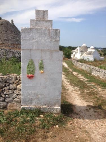 a stone monument with two windows on a road at Borgo trulli 1789 in Ostuni
