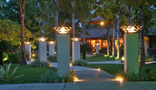 a pathway with lights in a yard at night at Segara Village Hotel in Sanur