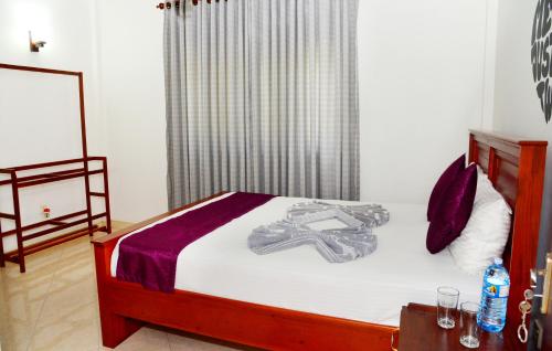 A bed or beds in a room at Cinnamon Holiday Inn