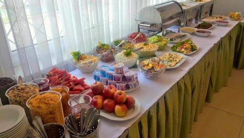a long table with plates of food on it at Hotel Felix in Kraków