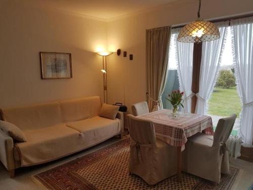 ein Wohnzimmer mit einem Sofa und einem Tisch in der Unterkunft Apartment Westerheide in Braderup