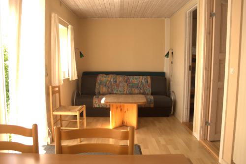 a living room with a couch and a table at Sorø Camping & Cottages in Sorø
