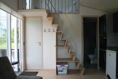 a staircase in a living room with a toilet at Sorø Camping & Cottages in Sorø