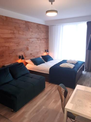 a bedroom with two beds and a couch at New Gudauri, loft 2, Apartment 309, RED CO in Gudauri