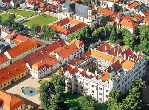 an overhead view of a large building with orange roofs at Penzion V Podzámčí Litomyšl in Litomyšl