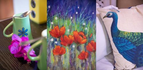 a painting of a peacock on a table next to a pillow at Blyde River Wilderness Lodge in Hoedspruit
