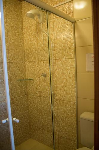 a shower with a glass door in a bathroom at Pousada Estrelas no Mar Florianópolis in Florianópolis