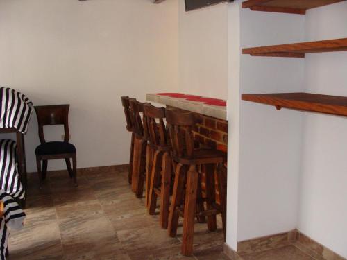 a room with a bar and some chairs at Villa Pepita Real in Villa de Leyva