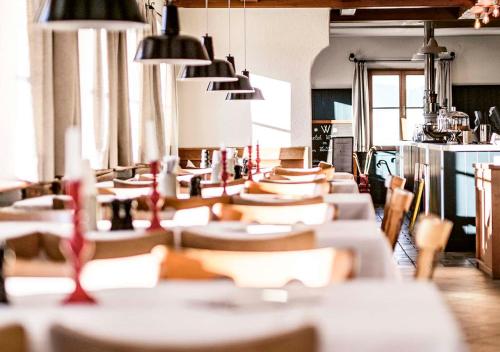 a row of tables and chairs in a room at Berghotel Altes Wallberghaus in Rottach-Egern