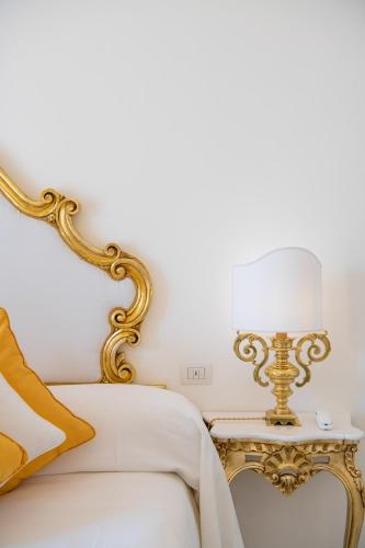a bedroom with a bed and a table with a lamp at Villa Yiara in Positano