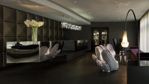 une salle à manger avec deux chaises et une table avec un vase dans l'établissement Roomers, Frankfurt, a Member of Design Hotels, à Francfort-sur-le-Main