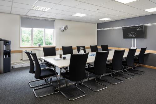 a conference room with a long table and chairs at Warwick Conferences - Scarman in Coventry