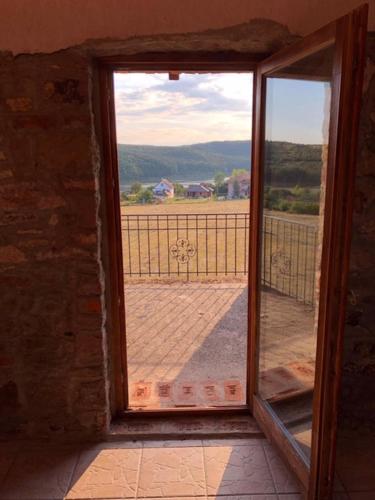 an open window with a view of a field at Magtár Vendégház Harsány in Harsány