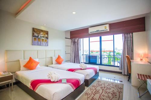 Ένα ή περισσότερα κρεβάτια σε δωμάτιο στο Ayara Grand Palace Hotel