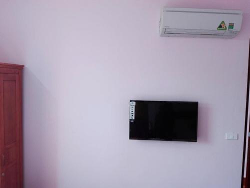 a flat screen tv on a white wall at Quoc Thai Sapa Hotel in Sa Pa