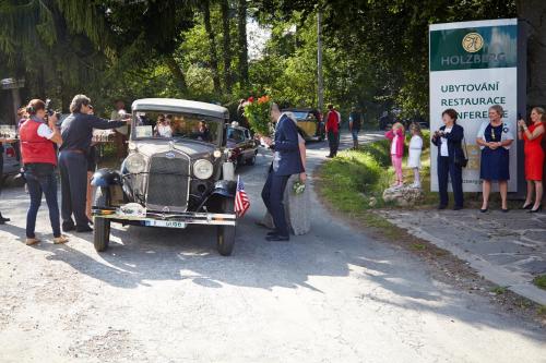 a group of people standing around an old car at Wellness Hotel Holzberg in Suchá Rudná