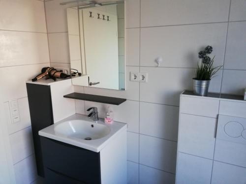 a bathroom with a sink and a mirror at Residenz Belair Schmidt in Dorum Neufeld