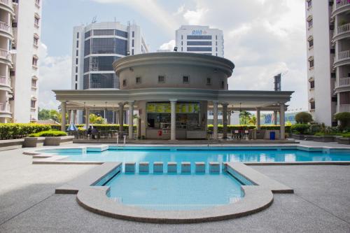 a swimming pool in front of a building with a gazebo at The FORUM condominium, Jalan Inai, Off Jalan Tun Razak in Kuala Lumpur
